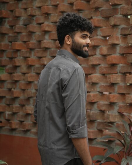 Back three-quarter view of a model wearing the Charcoal Slub Cotton Shirt.