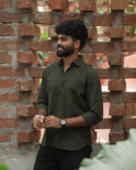 Angled view of a model wearing the Olive Slub Cotton Shirt.